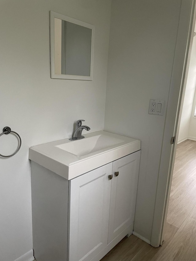 bathroom with hardwood / wood-style flooring and vanity