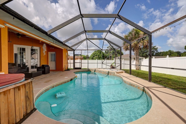 view of swimming pool featuring french doors, ceiling fan, a patio, and glass enclosure