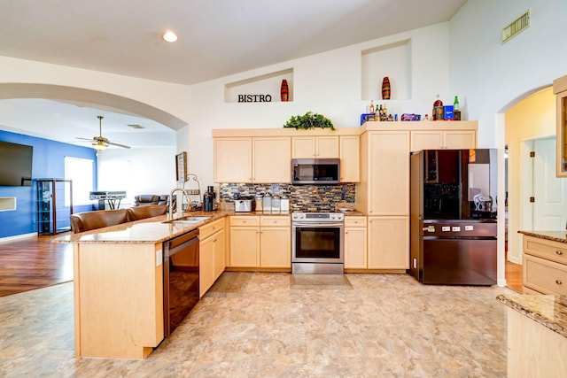 kitchen featuring light brown cabinetry, sink, kitchen peninsula, ceiling fan, and black appliances