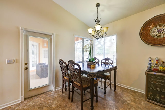 dining room featuring vaulted ceiling, beverage cooler, and an inviting chandelier