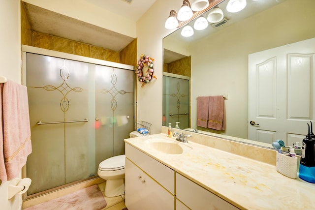 bathroom featuring tile patterned floors, vanity, toilet, and an enclosed shower