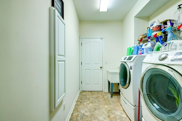 clothes washing area with separate washer and dryer