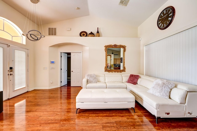 living room with high vaulted ceiling and hardwood / wood-style floors