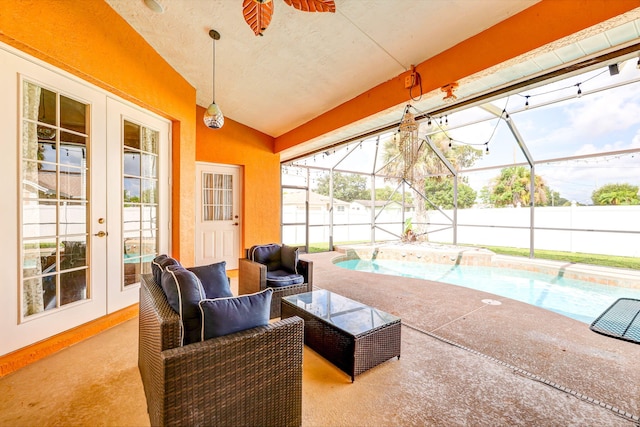 view of patio with a fenced in pool, a lanai, outdoor lounge area, and french doors