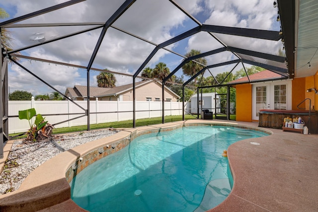 view of pool with a hot tub, a patio, glass enclosure, and french doors