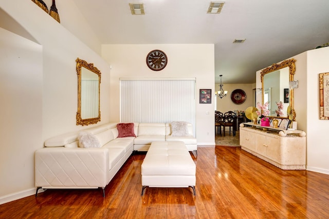 living room featuring hardwood / wood-style flooring and a chandelier