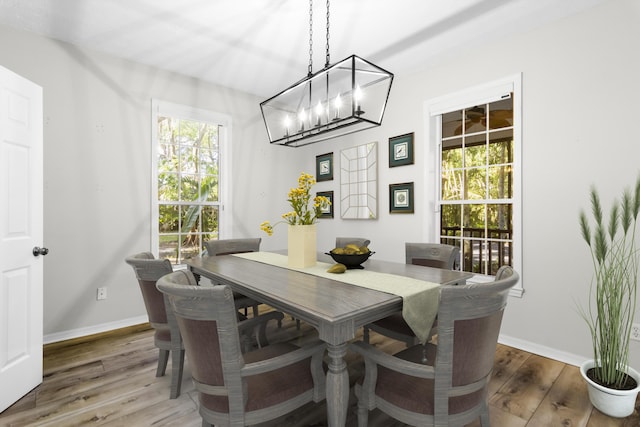 dining area featuring dark hardwood / wood-style floors and a notable chandelier