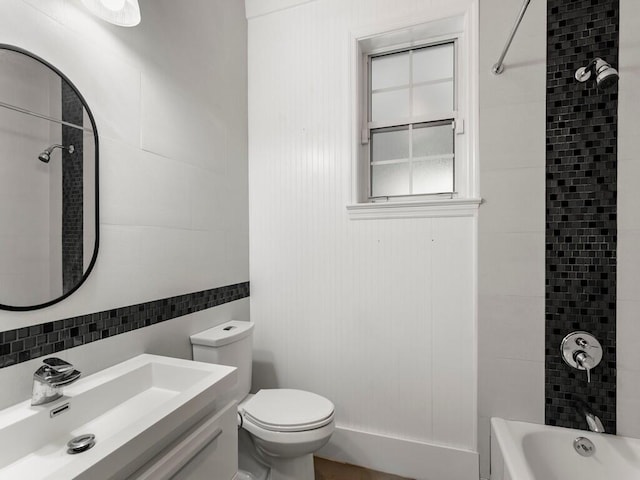 full bathroom with toilet, tiled shower / bath, backsplash, tile walls, and sink