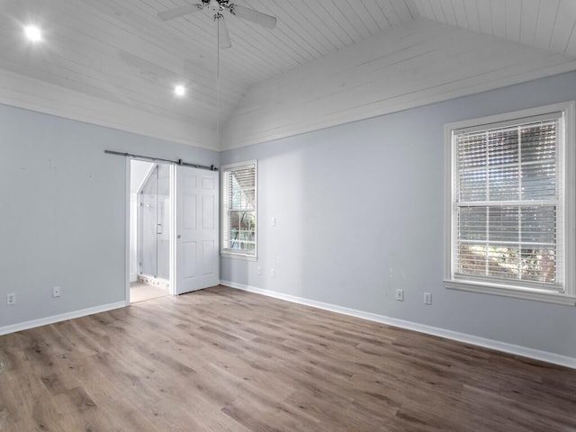 unfurnished bedroom with hardwood / wood-style floors, connected bathroom, vaulted ceiling, ceiling fan, and wooden ceiling