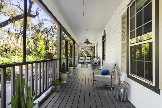 wooden terrace featuring ceiling fan and a porch