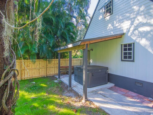 exterior space with a hot tub