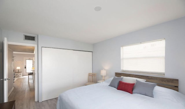 bedroom with a closet and light hardwood / wood-style flooring