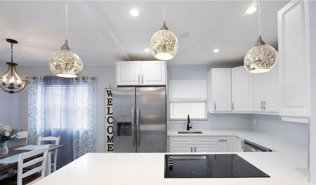 kitchen with sink, white cabinetry, appliances with stainless steel finishes, and hanging light fixtures