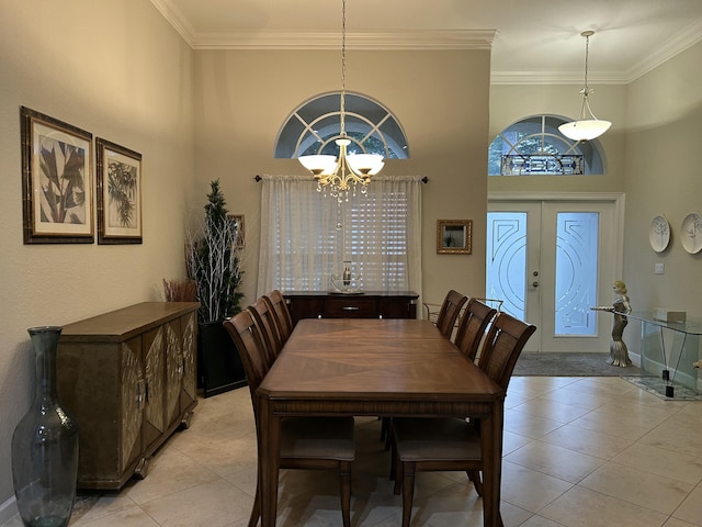 tiled dining area featuring french doors, a notable chandelier, a high ceiling, and ornamental molding