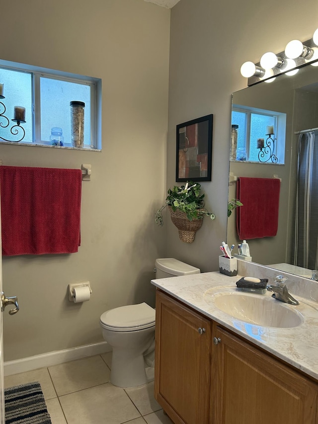 bathroom with toilet, tile patterned flooring, and vanity