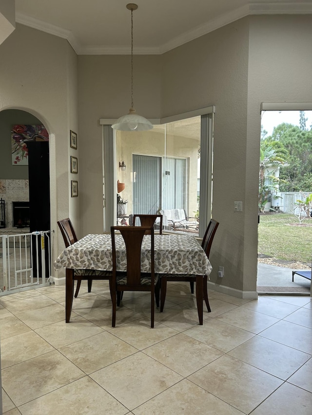 dining space featuring light tile patterned floors and ornamental molding