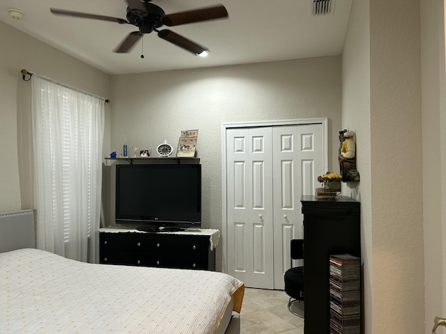 bedroom with ceiling fan and a closet