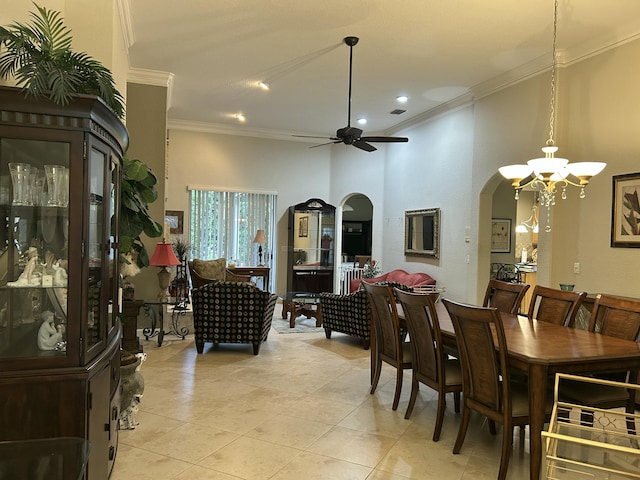 dining area featuring light tile patterned floors, a towering ceiling, ceiling fan with notable chandelier, and ornamental molding