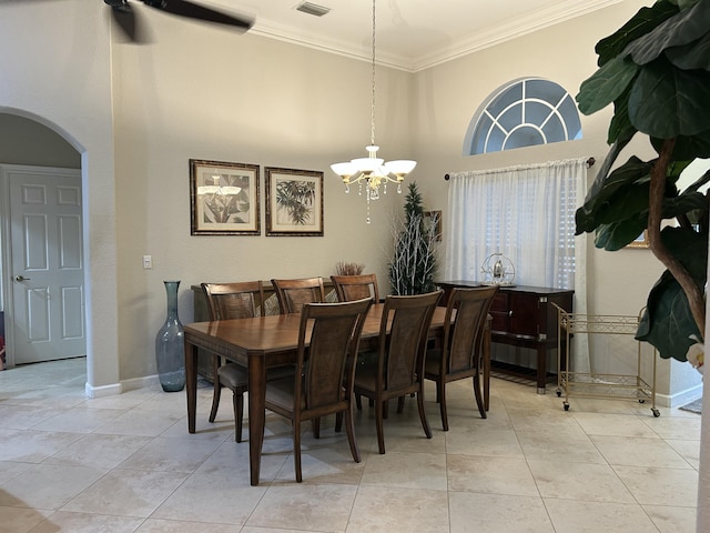 tiled dining space featuring a chandelier and crown molding