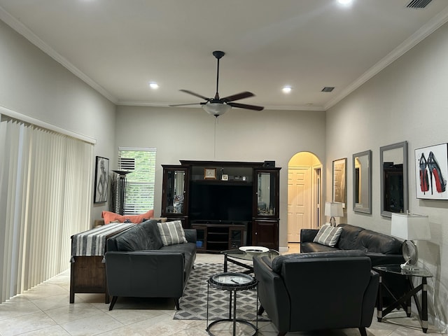 tiled living room with ceiling fan and ornamental molding