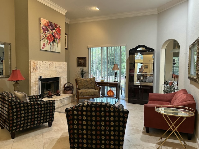 tiled living room featuring a tiled fireplace and crown molding