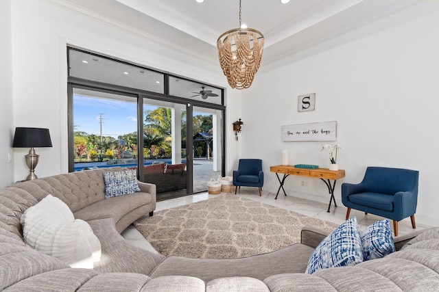 living room featuring an inviting chandelier, crown molding, and a tray ceiling