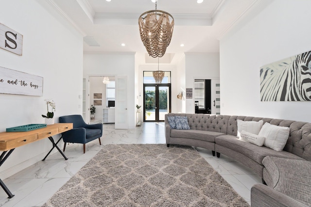 living room with crown molding, a raised ceiling, french doors, and a notable chandelier