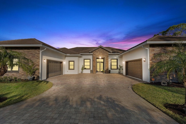 view of front facade with a garage and a yard