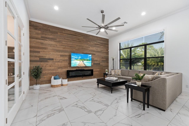 living room with ceiling fan, ornamental molding, and wood walls