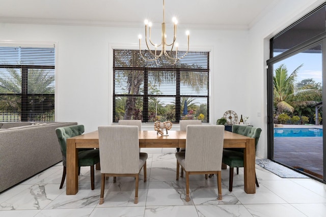 dining area featuring ornamental molding and a chandelier