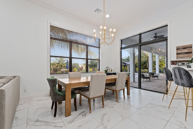 dining area featuring ornamental molding and an inviting chandelier