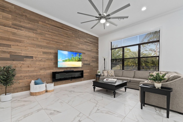 living room featuring ceiling fan, ornamental molding, and wood walls