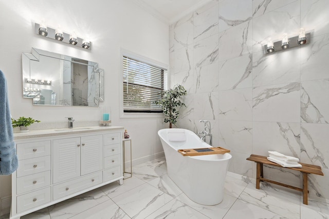 bathroom with ornamental molding, a tub to relax in, and vanity