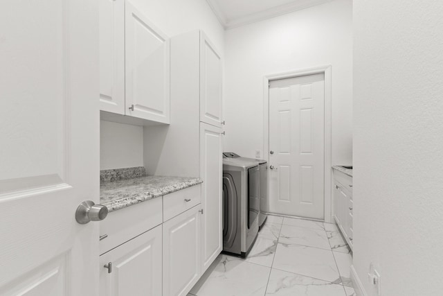 laundry area featuring washer / clothes dryer, crown molding, and cabinets