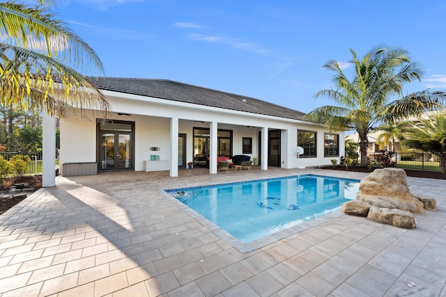 view of pool with a patio, ceiling fan, and french doors