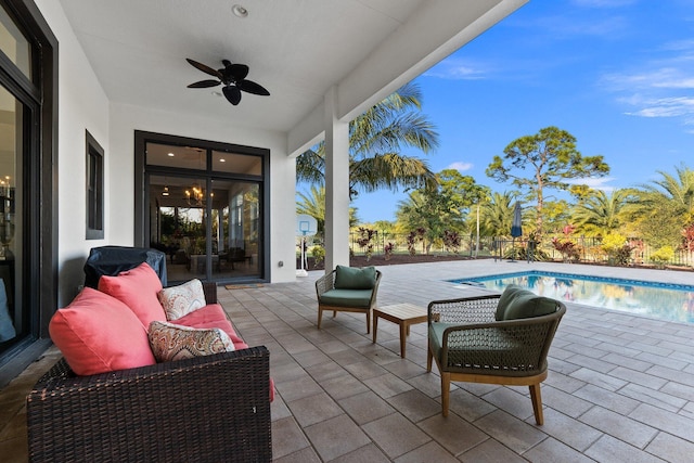 view of patio / terrace with ceiling fan and an outdoor living space