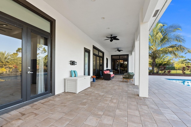 view of patio / terrace with french doors, ceiling fan, and a fenced in pool