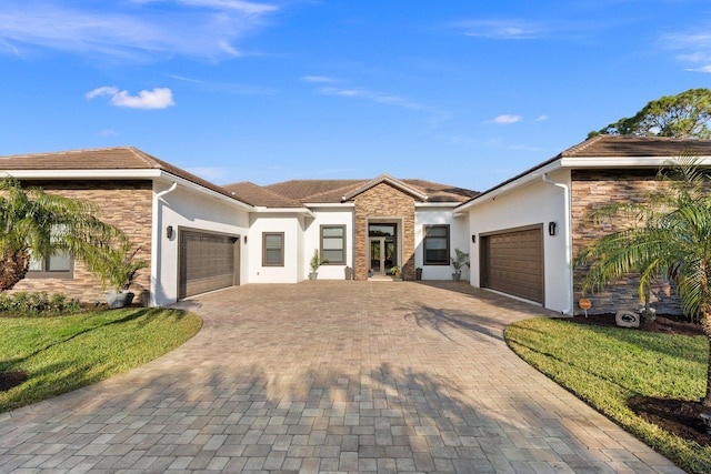 ranch-style house featuring a garage and a front yard