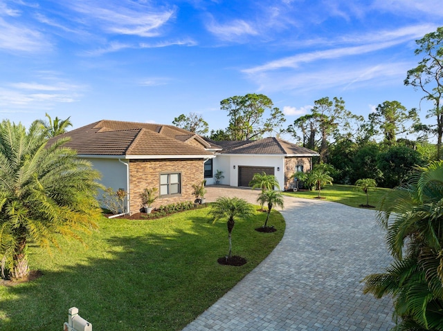 ranch-style home featuring a garage and a front yard