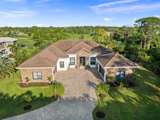 view of front of home with a garage and a front lawn