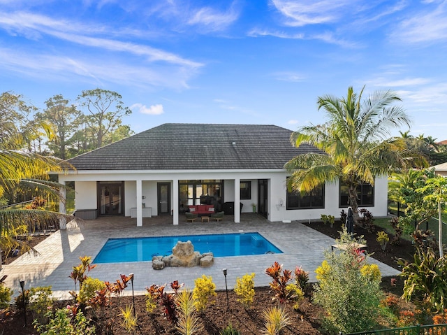 view of swimming pool with an outdoor living space and a patio area