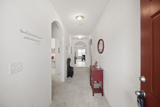 hall featuring light colored carpet