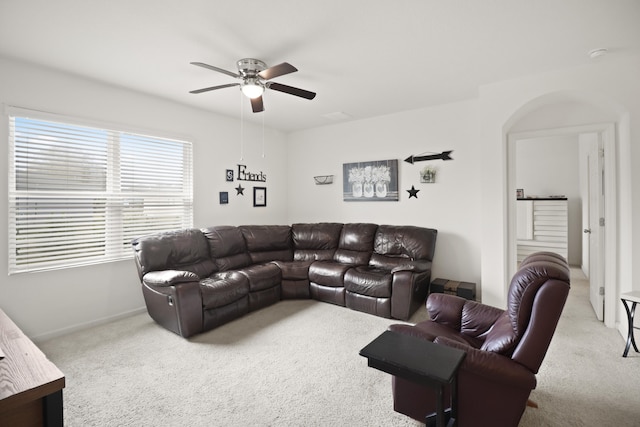 carpeted living room with ceiling fan