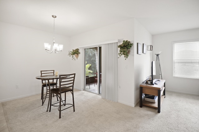 dining area featuring a healthy amount of sunlight, light colored carpet, and an inviting chandelier