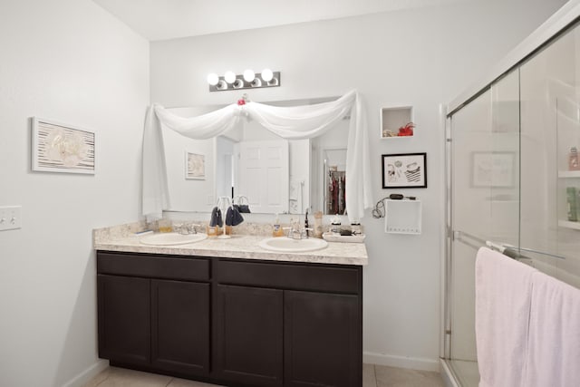 bathroom featuring vanity, tile patterned floors, and walk in shower