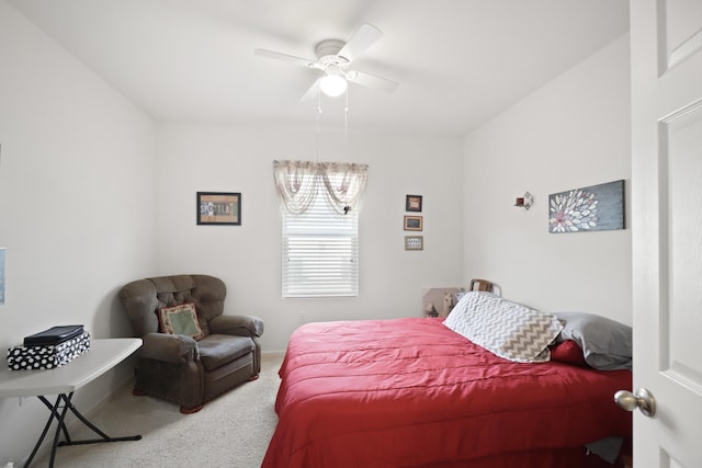 bedroom featuring ceiling fan with notable chandelier and carpet flooring