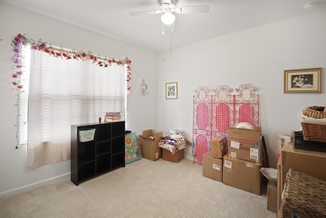 playroom with ceiling fan and light colored carpet