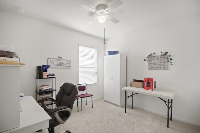 office featuring light carpet and ceiling fan