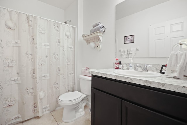 bathroom with vanity, tile patterned floors, and toilet