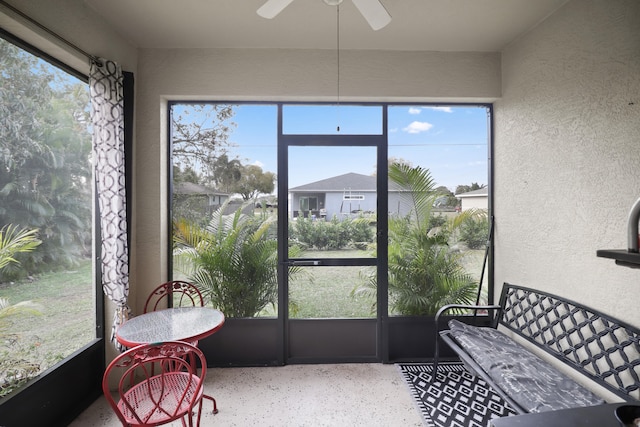 sunroom / solarium featuring ceiling fan